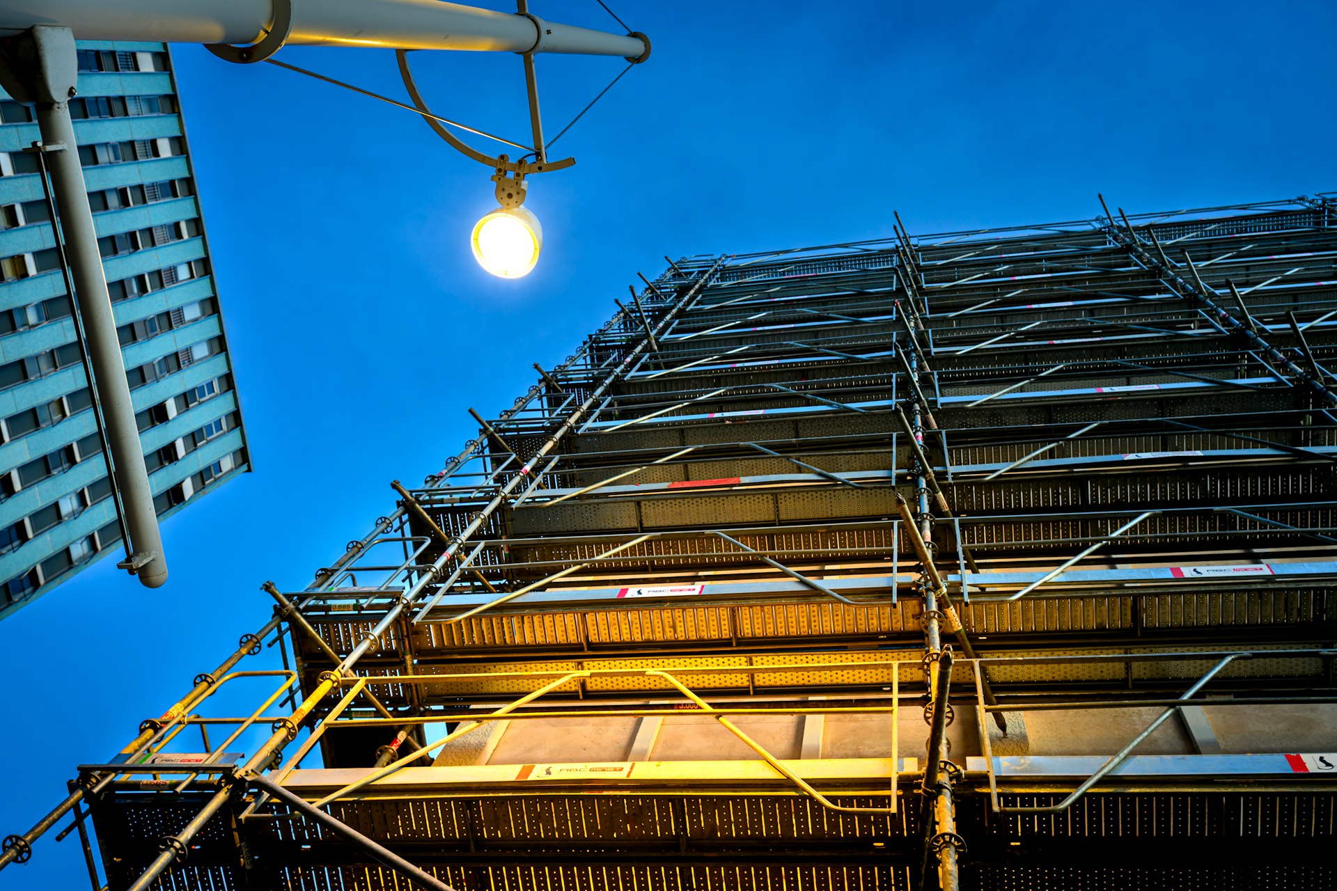 Scaffolding on building against a dark blue sky.